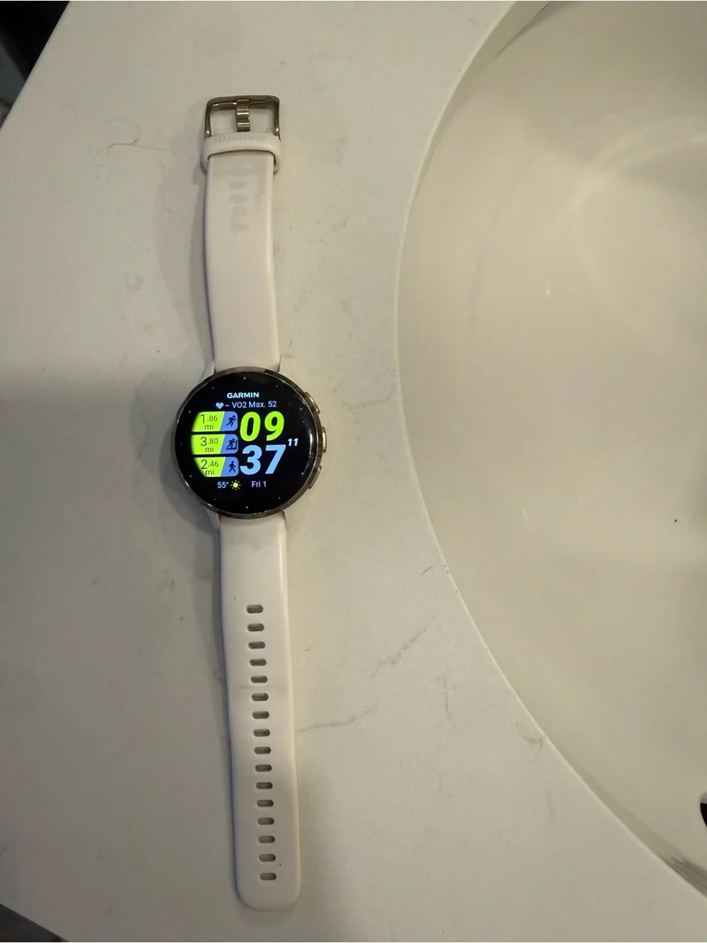 garmin white silicone smartwatch with colorful activity display